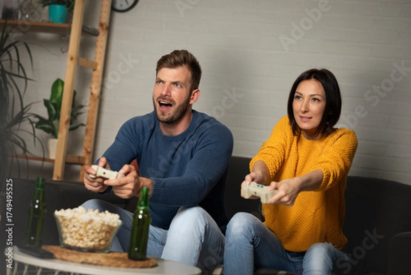 Obraz Young couple playing video games at home