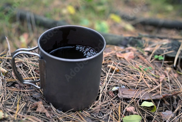 Obraz Metal Mug with Coffee on Forest Ground