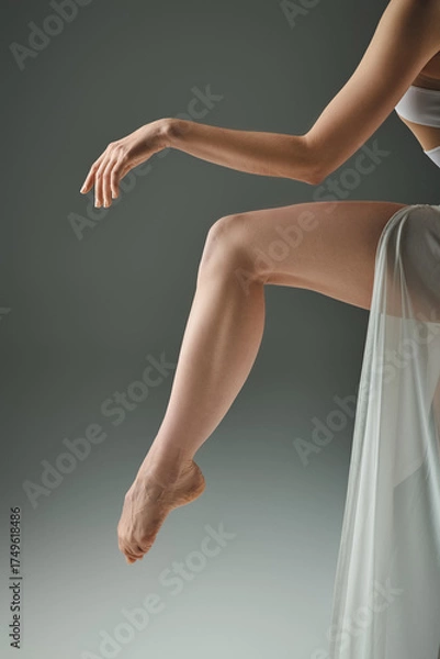 Obraz Beautiful young woman performs graceful ballet movements in a serene setting