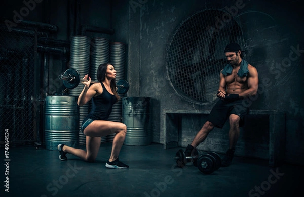 Fototapeta Young people making functional training in the grungy gym
