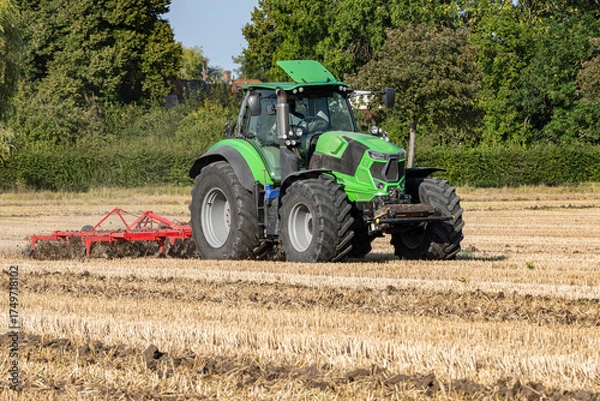 Obraz Tractor cultivating a stubble field after harvest - 8574
