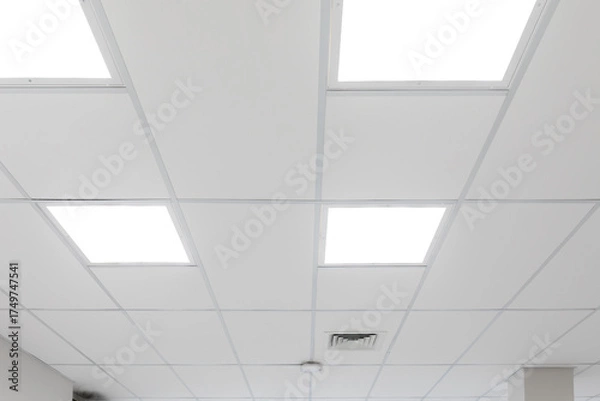 Obraz White ceiling with panel lighting. Light panels integrated in suspended ceiling, neutral colour temperature, optimal office lighting. Real photo