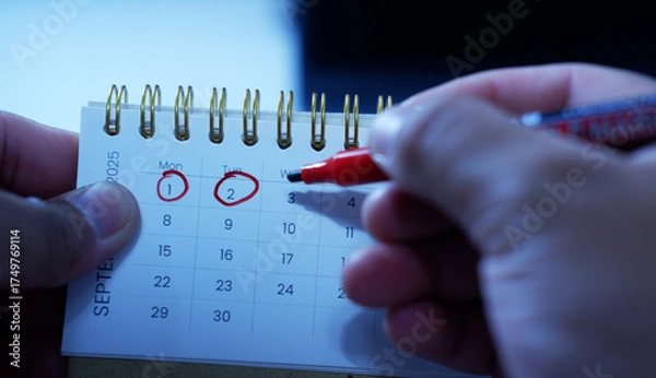 Obraz A person marks a calendar with a red marker, circling dates and marking deadlines and progress. Time management, planning, scheduling Important days, Deadlines

