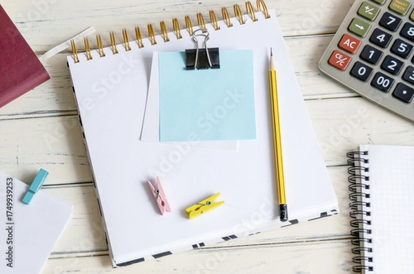 Fototapeta A blank post-it note on my notepad, next to my glasses and documents. Concept of business and finance. Calculator.