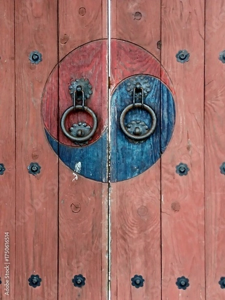 Fototapeta Traditional Korean wooden door decorated with Taegeuk patterns - Taegeuk symbol is typically associated with Korean traditions and represents balance in the universe
