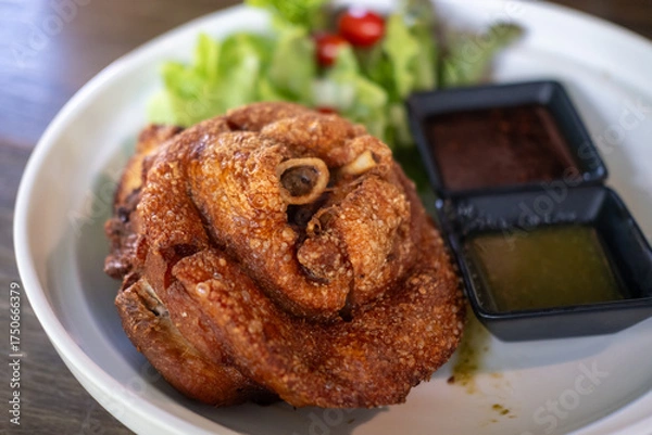 Fototapeta Crispy German pork knuckle served in the restaurant