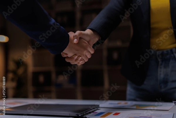 Fototapeta B2B, handshake and partnership with business women in office at night for thank you or welcome. Bokeh, deal and mockup with employee people shaking hands for team onboarding or recruitment on space
