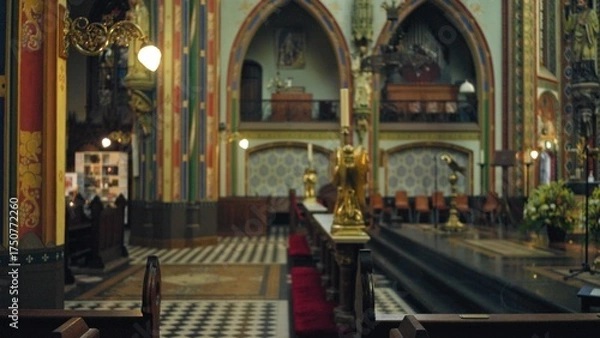 Fototapeta Interior of a vibrant, colorful catholic church with defocused, blurred architectural features and intricate decorations visible indoors.