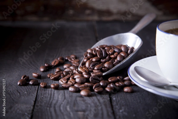 Fototapeta Coffee beans on black wood table with beautiful studio light