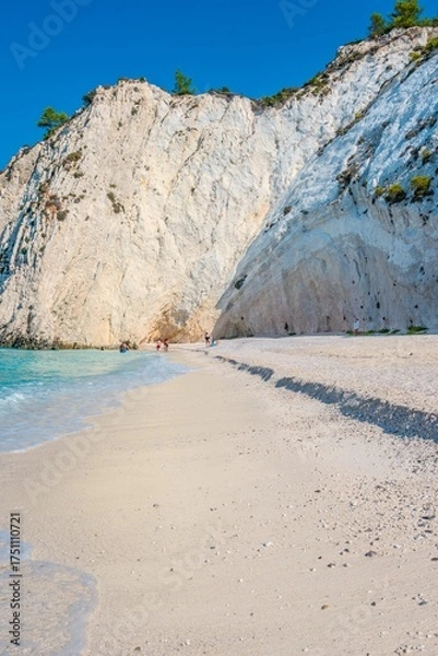 Fototapeta Towering White Cliffs Overlooking the Pristine White Pebble Beach and Turquoise white rocks beach in Kefalonia, Greece
