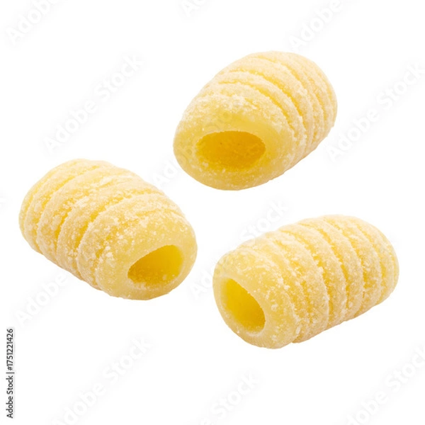 Obraz Close-up of three cylindrical, ridged pasta shapes against a black background