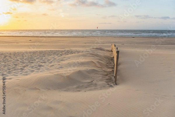 Fototapeta evening light and water makes structures in the sand at the North Sea, natural art on the sandy beach, a stream on the beach forms water and sand, wave-shaped depressions form a beautiful pattern