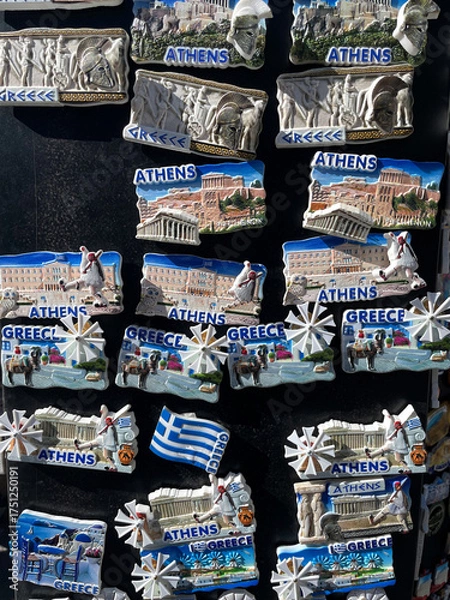 Obraz Colorful souvenir magnets from Athens, Greece, featuring famous landmarks such as the Parthenon, Acropolis, Greek flag, and Santorini scenery. A bright collection symbolizing Greek culture and tourism