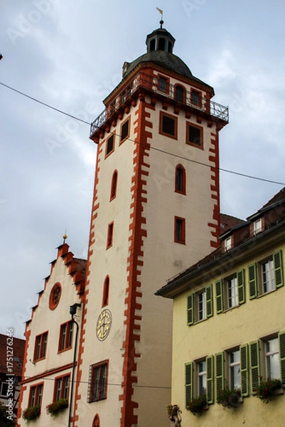Fototapeta close up of the facade of an old german red-white church tower 