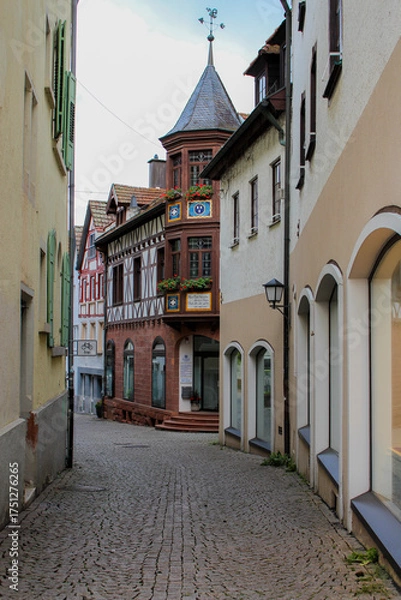 Fototapeta narrow street in old town in germany with old stone and half-timbered fachwerk buildings