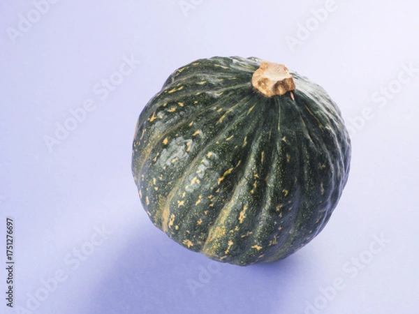 Obraz Green pumpkin on purple background