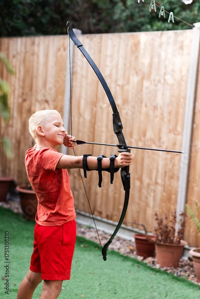 Obraz Boy Practicing Archery in the Back Garden