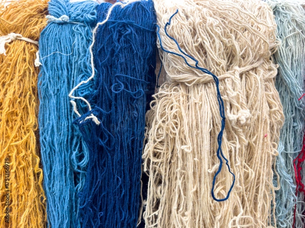 Fototapeta Colorful silk threads for weaving in a textile factory , Cotton color natural dyes handmade, old weaving loom and thread of yarn