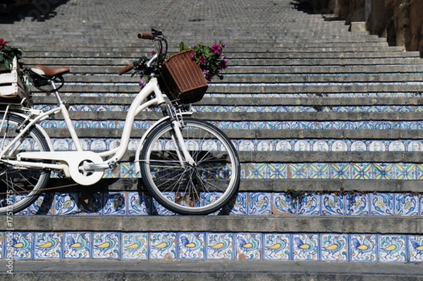 Fototapeta Bicycle on stairway with steps made of ceramic tiles in the town famous of pottery production - Caltagirone (Caltaggiruni), Sicily, Italy