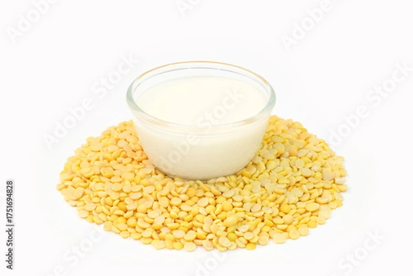 Obraz Soy milk in a glass cup and hsoybeans on a wooden table. Healthy food concept.