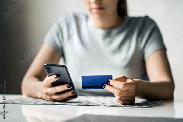 Fototapeta Credit card and phone for payment. Woman shopping and paying. Scam of fraud. Mobile transaction. Money in bank transfer. Purchase with smartphone app. Girl or student. using technology.
