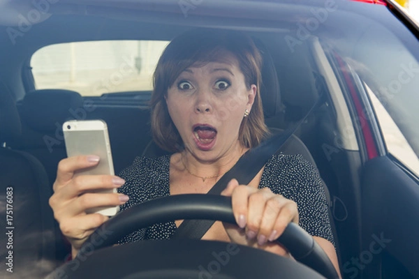 Obraz beautiful woman  driving car while texting using mobile phone distracted