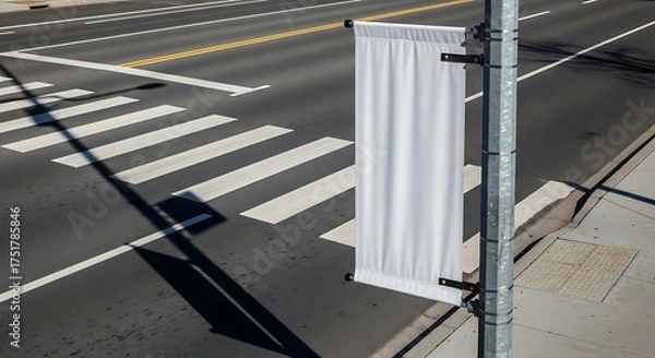 Fototapeta Blank White Banner on Street Pole at Crosswalk, Sunny Day