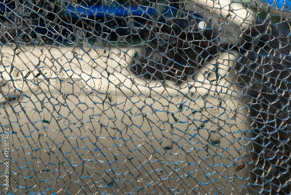 Fototapeta Intricate patterns of shattered glass reflecting a hidden world in a vibrant urban setting