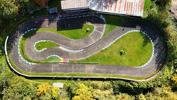 Fototapeta Aerial View of a Miniature RC Car Racing Track Surrounded by Greenery