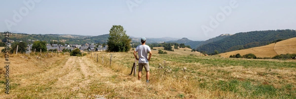 Fototapeta Panoramic view of a tourist admiring the scenery in Besse-et-Saint-Anastaise, France