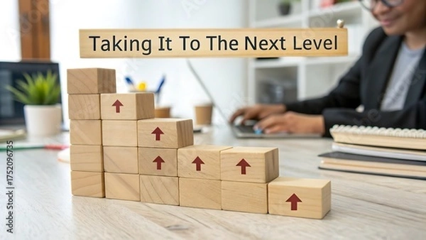 Fototapeta Next Level Growth Concept – Wooden Arrow Blocks with Business Laptop & Desk Setup 