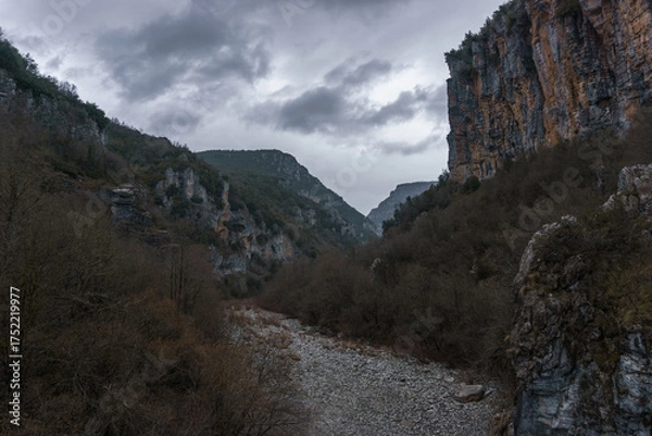 Fototapeta View of the impressive Vikos gorge in the Zagoria region at Pindus Mountains on a dark winter day with atmospheric mood, Epirus, Greece