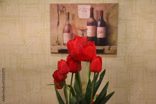 Fototapeta A bouquet of unopened tulip buds set against a softly lit wall