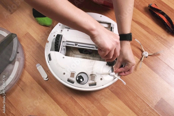 Fototapeta Maintenance and part replacement of robotic vacuum cleaner