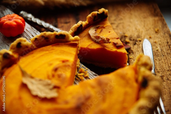 Fototapeta Traditional pumpkin pie preparation with filling, dough and ingredients on dark rustic background, top view, retro styled, frame