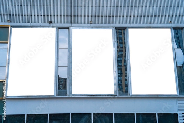 Fototapeta triple blank billboards and high rise business building