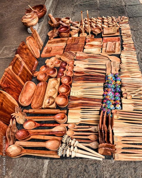 Fototapeta Handcrafted wooden kitchen utensils and bowls displayed at a Mexican artisan market