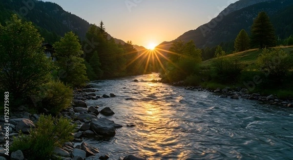 Obraz A river flows through a valley with mountains, sun setting, casting rays