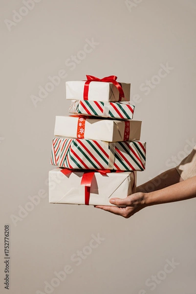 Fototapeta Stack of Christmas Presents Held in Hand