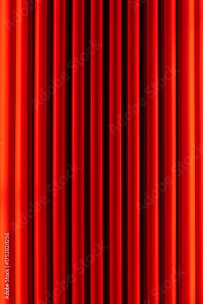 Fototapeta vibrant red velvet curtains with vertical pleats, creating a rich, textured background. The curtains are evenly spaced, with a slight sheen that highlights their luxurious fabric.