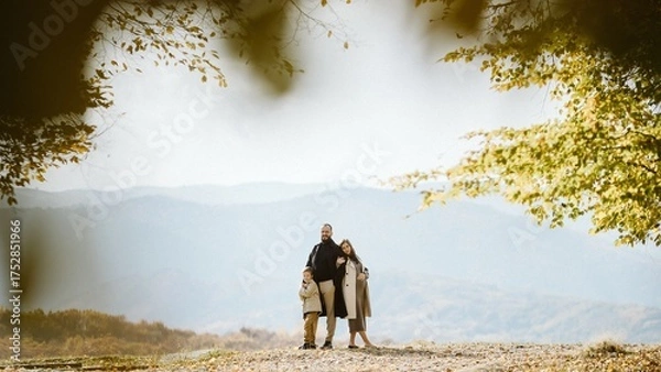 Obraz Family standing together in autumn mountains expecting baby