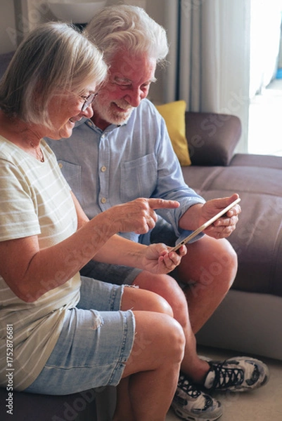 Fototapeta Senior couple spending quality time together at home, sharing a tender and loving moment that reflects affection, companionship, and a healthy, peaceful retired lifestyle