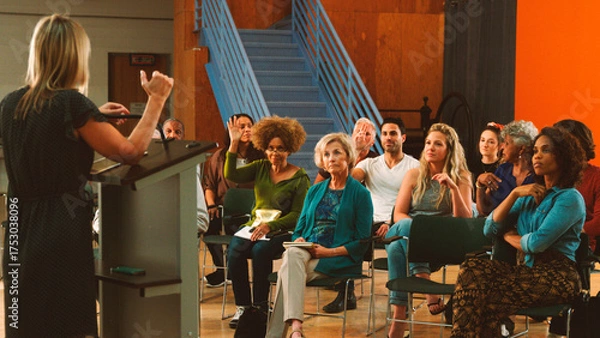 Fototapeta Group Attending Neighborhood Meeting In Community Center Asking Questions