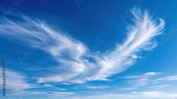 Fototapeta Cirrus cloud formation against a vivid blue sky, creating a striking and ethereal atmospheric scene