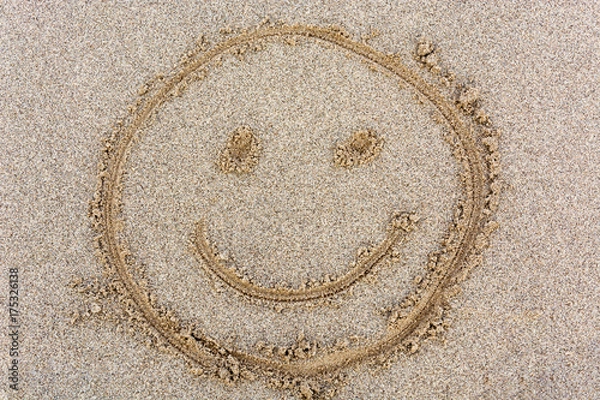Fototapeta Smiley face drawn in the sand from above