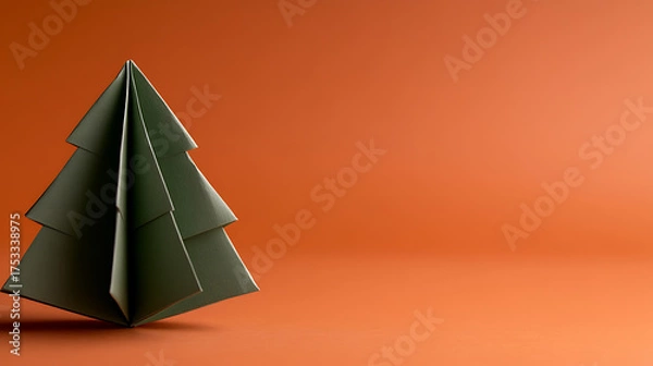 Fototapeta Minimalist Origami Tree: A simple green paper tree on a vibrant orange background. Perfect for seasonal crafts and decorations.