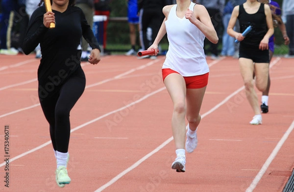Obraz Relay Race at Track Meet With Runners in Action
