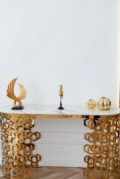 Obraz A table with a metallic gold underframe. Luxurious minimalist interior. White and gold palette,