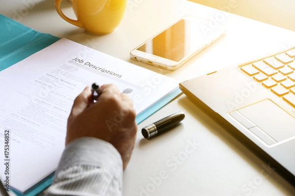 Obraz businessman Reading job description paper In office.