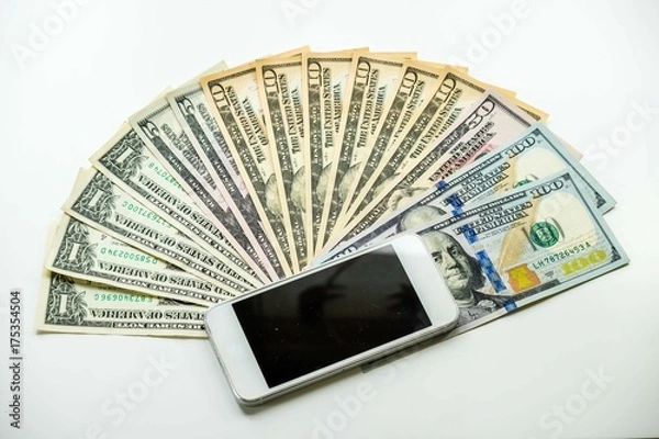 Fototapeta Mobile smartphone on US dollar banknote, digital money concept